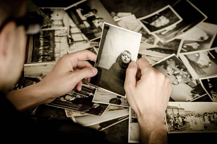 Narrative Counseling: person looking through old photos.